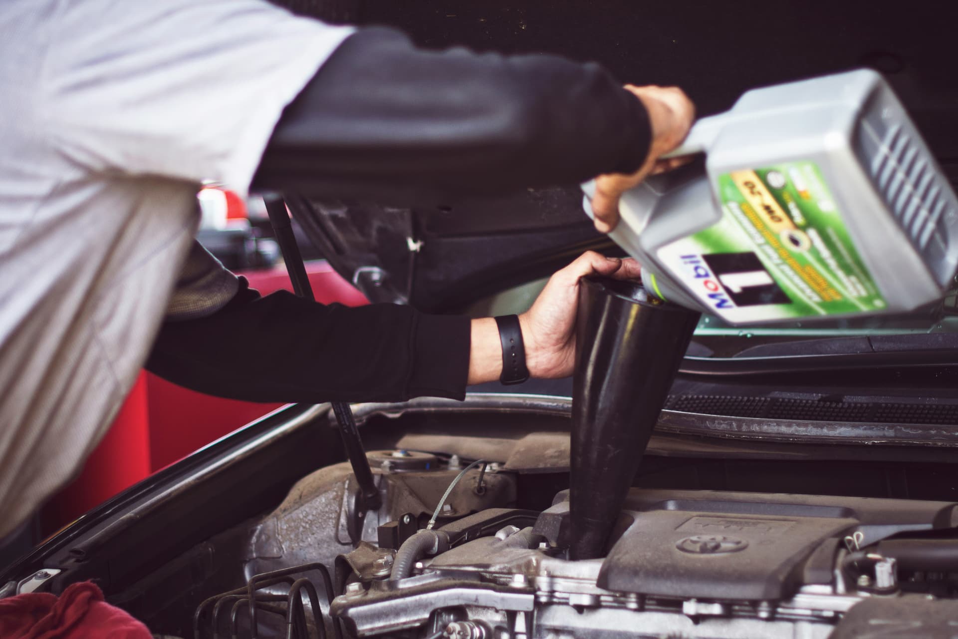 guy changing his car oil